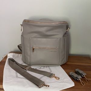 Fawn Design diaper bag in gray with stroller hooks